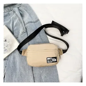 Macro detail of beige nylon waist bag with Fashion patch on denim background