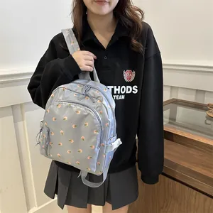 Light blue floral backpack with pink print for students featuring adjustable side buckles