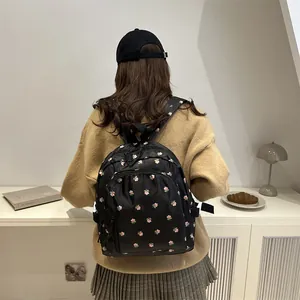 Black floral nylon backpack for school with pink flower pattern and adjustable straps