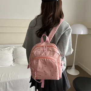 Pink floral canvas backpack for girls with adjustable straps and front zipper pocket
