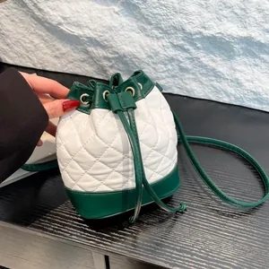 Green and white quilted drawstring bucket bag with elegant rhombus stitching design