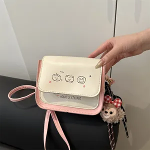 Pink and white matte crossbody bag with cute cartoon prints and a plush bear charm