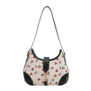 Minimalist white shoulder bag with red cherry print and black leather trim for women