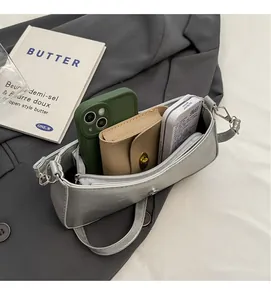 Interior view showing the spacious capacity of this silver-grey faux leather crossbody bag