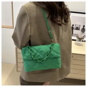 Détail du sac bandoulière matelassé vert avec chaîne en résine et bandoulière ajustable