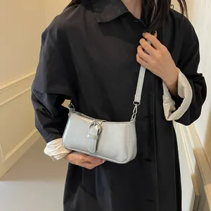 Minimalist silver metallic underarm bag for women featuring a sleek round buckle and strap