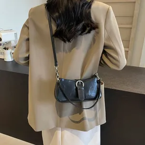 Minimalist black baguette bag with silver buckle and slim leather strap for women