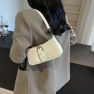 Minimalist cream faux leather baguette bag with silver buckle and detachable strap