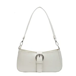 Minimalist white faux leather baguette bag with a large silver circular metal buckle