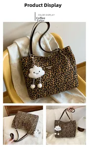 Detail of coffee brown leopard print tote bag with plush cloud charm and long straps