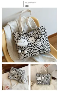 Detail of off-white leopard print tote bag featuring a cute plush cloud charm