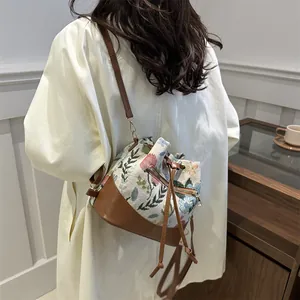 Floral embroidery drawstring bucket bag with brown leather straps for women