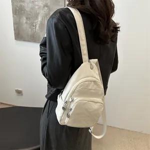 Minimalist white nylon chest bag for women with adjustable strap and zip pockets