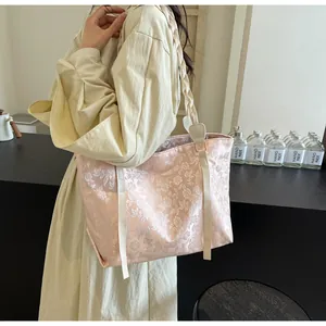 Close-up of pink floral jacquard tote bag with woven shoulder strap and fine texture
