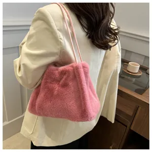 Detail of pink faux fur shoulder bag featuring soft texture and thin straps for autumn