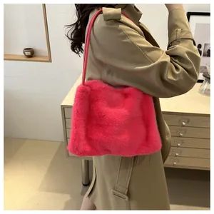 Detail of hot pink faux fur shoulder bag with plush texture on a khaki coat