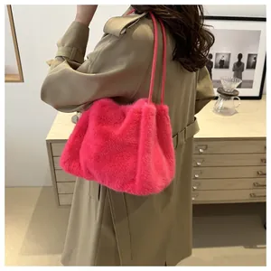 Detail of soft fuchsia faux fur tote bag showing the fluffy texture and slim leather straps