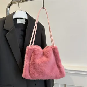 Pink faux fur shoulder bag with minimalist fluffy texture and slim straps for autumn