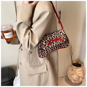 French retro leopard print shoulder bag with a red bow detail on a stylish woman