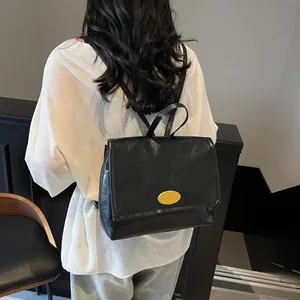 Minimalist black faux leather vintage backpack with gold metal flap for women