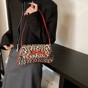 French retro leopard print shoulder bag with red bow detail and thin red strap