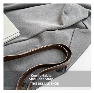 Detail shot of the comfortable brown leather shoulder strap on a retro crossbody bag