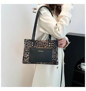 Fashionable leopard print tote bag styled with a minimalist trench coat in a chic setting