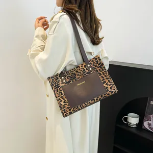 Fashionable leopard print tote bag for women with brown leather pocket and gold lettering