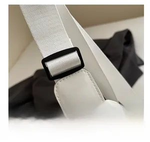 Close-up of adjustable strap buckle on a minimalist white PU leather crossbody bag