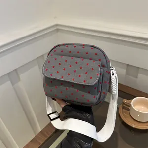 Chic dark grey canvas crossbody bag with red heart pattern and wide white shoulder strap