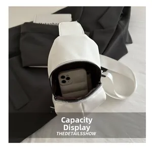 Macro detail of white crossbody bag interior showing storage capacity for a smartphone