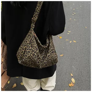 Photo en extérieur d'un sac hobo léopard avec bandoulière réglable sur un mannequin