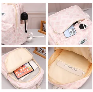 Detail view of pink backpack showing woven texture, side pockets, and large capacity