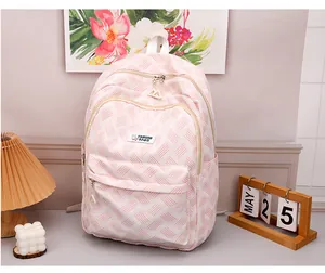 Detail of pink striped casual backpack featuring a FASHION BAGS label on front pocket