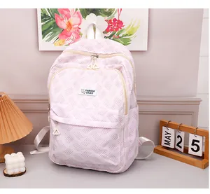 Close-up of pink and white woven texture backpack with front zipper and fashion label