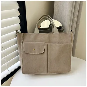 Détails du sac fourre-tout en velours côtelé kaki avec poches avant et bouton doré