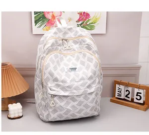 Detail of white woven backpack featuring double zippers and front fashion logo patch