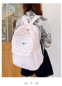 Detailed back view of a pink and white twill backpack with adjustable wide straps