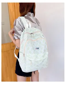 Side view of lightweight light green striped casual backpack with front zipper pocket