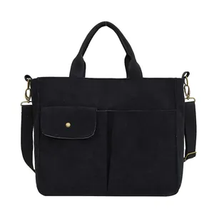 Sac cabas en velours côtelé noir avec bandoulière réglable et poches frontales