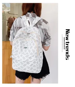 Detail view of lightweight white backpack with grey wave patterns and front zipper pockets