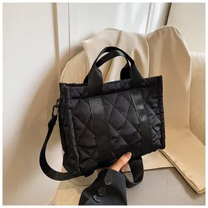 Close-up of black quilted nylon bag showing detailed stitching and textured fabric