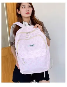 Detail of pink and white striped canvas backpack with Fashion Bags woven label and front pocket