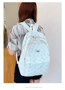 Detail view of light blue striped canvas backpack with adjustable straps and front pockets