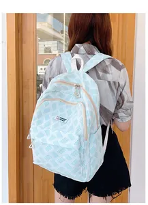 Detail of light blue waffle texture backpack with FASHION BAGS rabbit patch and zipper