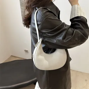 Minimalist beige suede hobo shoulder bag for women with sleek crescent shape design