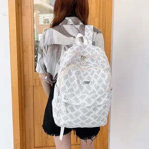 Minimalist white geometric canvas backpack with dual zippers and large capacity