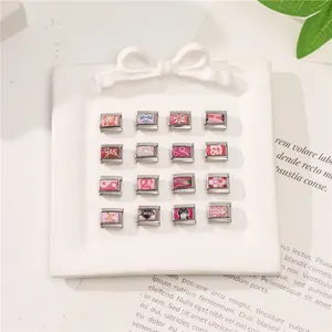 Italian charms set with pink enamel hearts and flowers on a white porcelain dish