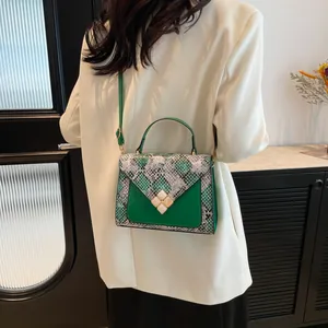 Elegant dark green snakeskin flap handbag for women with adjustable shoulder strap