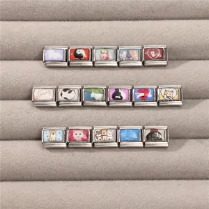 Macro detail of various stainless steel Italian charms featuring cute cat and dog patterns
